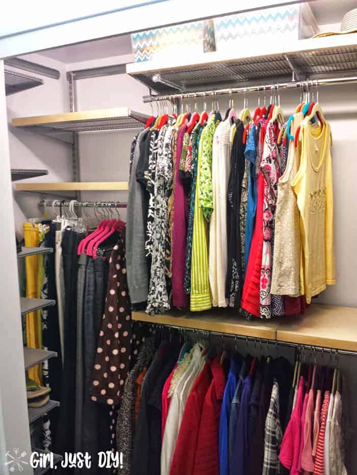 Left view with female clothes hung after closet makeover but empty shelves.