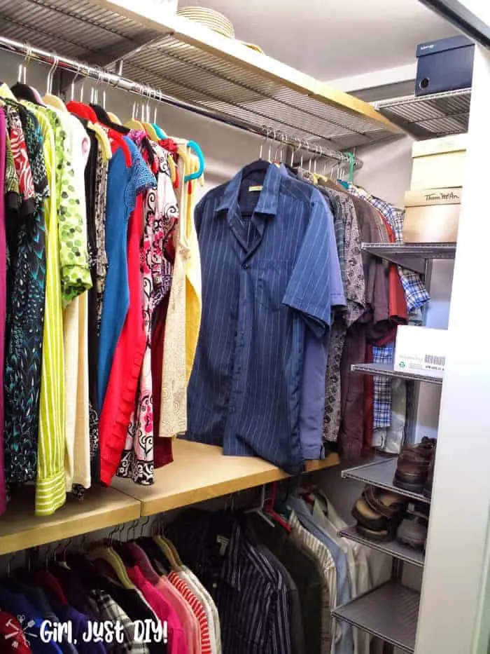 Man's clothes hung on right side after closet makeover.