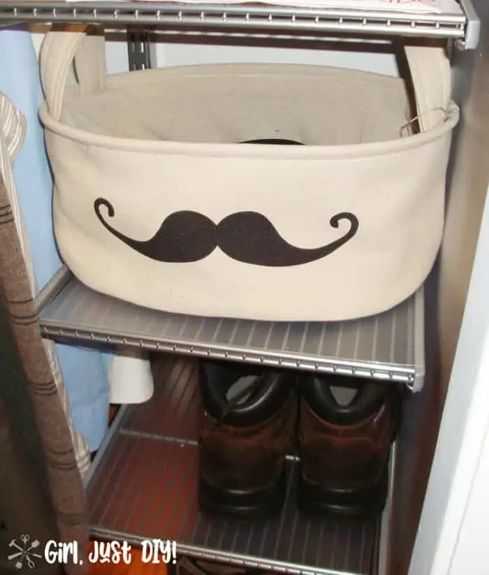 Fabric basket with mustache image on shoe shelf after closet makeover.