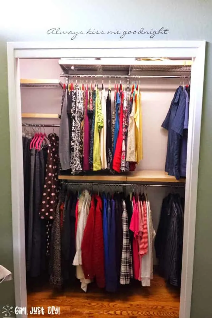 Closet after elfa system installed and clothes hung but shelves still empty.