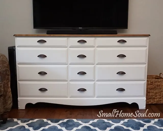 TV Console cabinet with tv mounted to wall above.