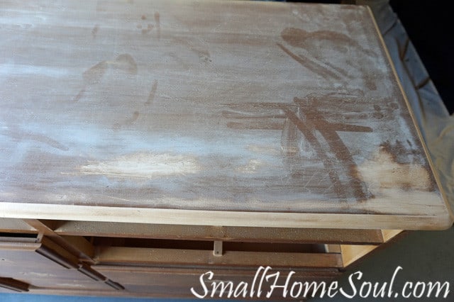 Sanding the top of the dresser, lots of sanding dust.