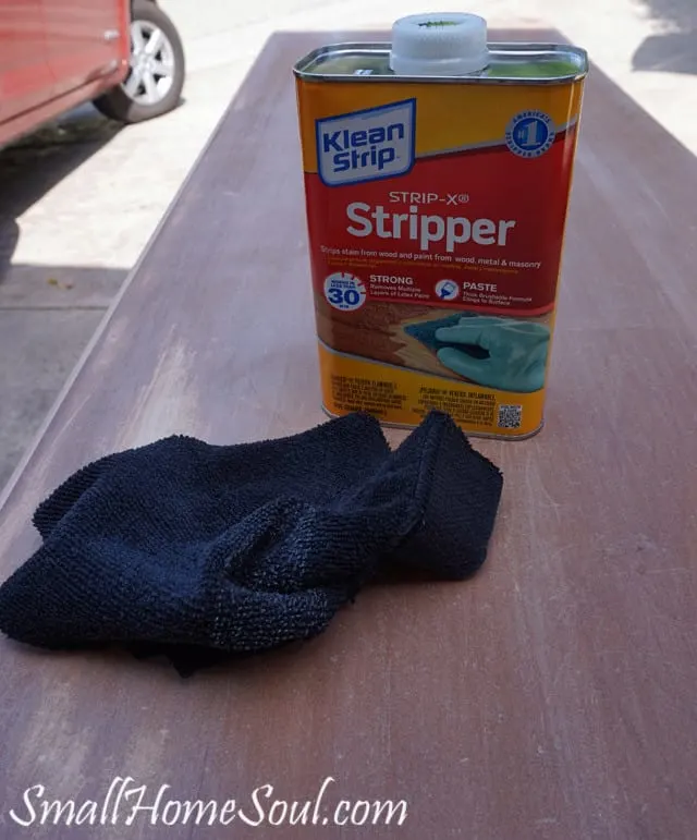 Can of paint stripper and a rag on top of dresser.