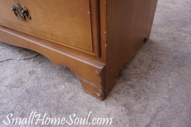 Dings and scuffs on the base of the dresser.