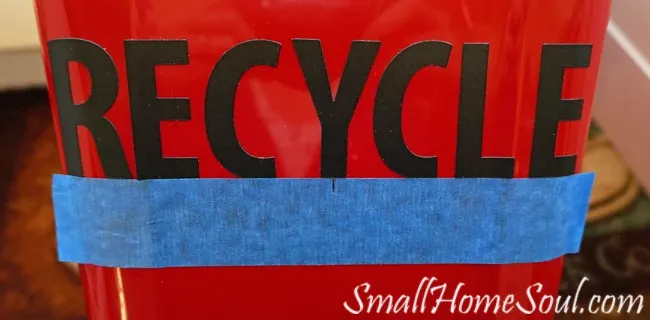 Blue tape helps keep letters level on kitchen Recycling Center cans