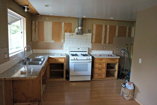 Partial demo of kitchen, uppers removed, before renovation begins.