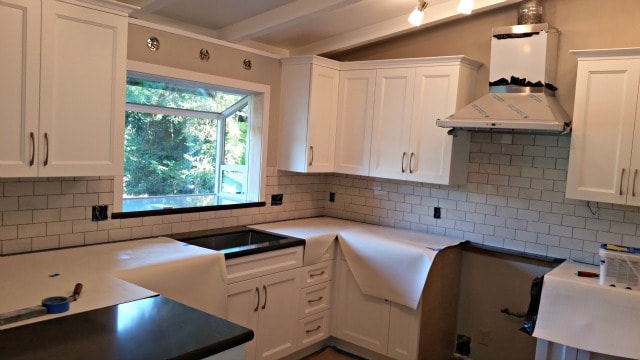 Subway tile backsplash installed but not grouted as part of Kitchen Renovation.