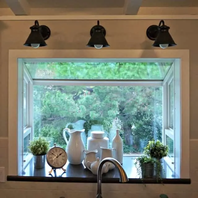 closeup of garden window and goose neck lights in completed Kitchen Renovation.