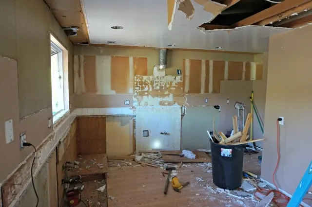 Kitchen demo underway, ceiling coming down and all cabinets gone.