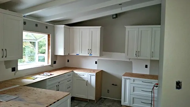 New cabinets installed and plywood counter top under layment.