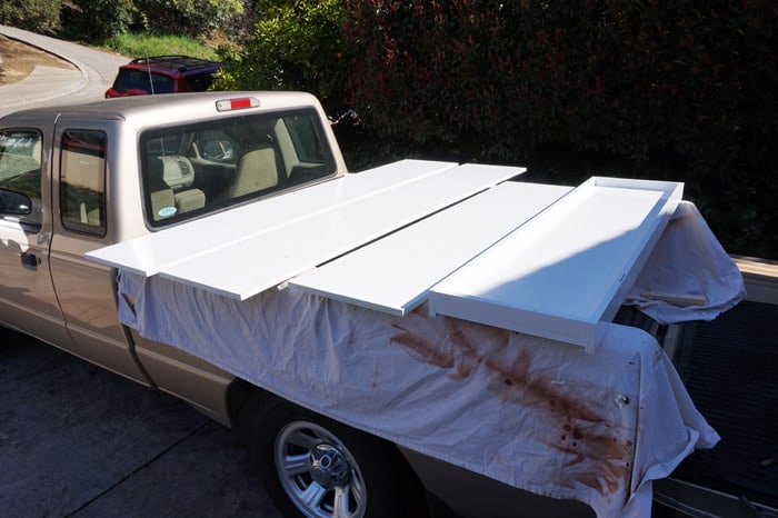 Sections of painted murphy bed drying on truck bed