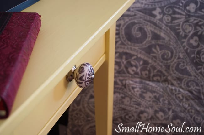 Hacked Ikea Nightstands with buttery yellow paint and new drawer pulls that play off the comforter - www.smallhomesoul.com