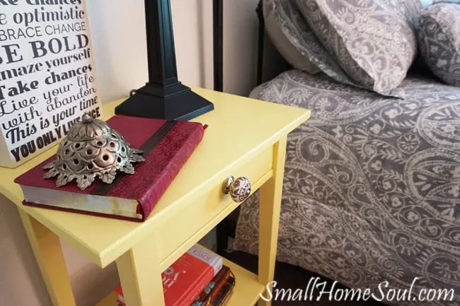 Hacked Ikea Nightstands with buttery yellow paint and new drawer pulls that play off the comforter - www.smallhomesoul.com