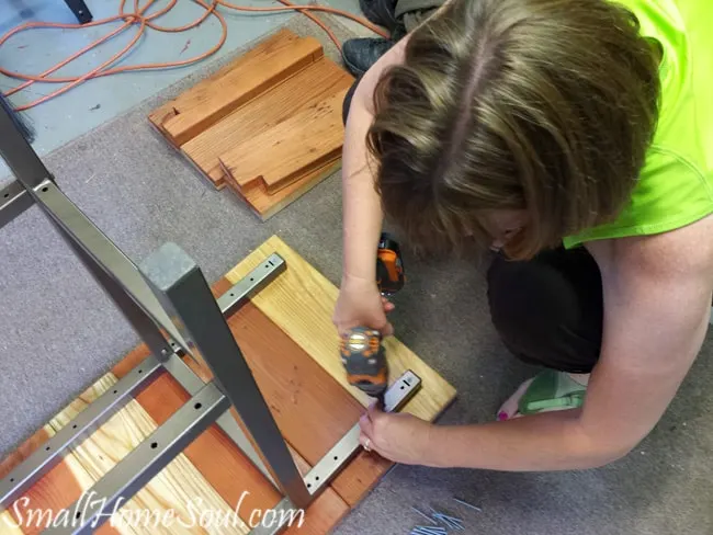 Screwing bbq cart frame to redwood boards for top of patio cart.