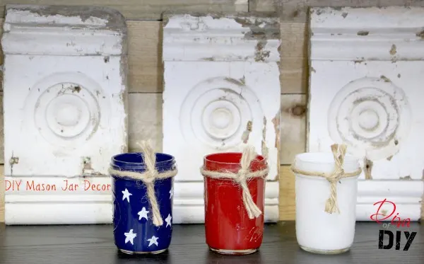 Red white and blue painted pint size mason jars in front of wood detail.