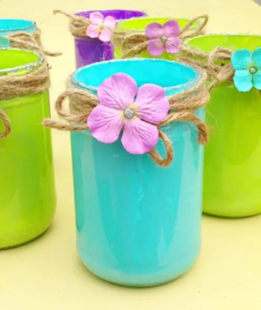 Sea blue, lime green and purple painted pint mason jars with jute twine bows.