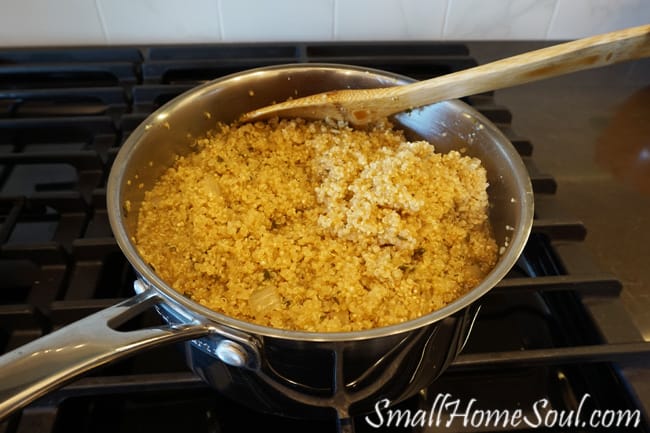Quinoa cooking in skillet for savory quinoa side dish.