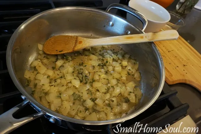 Onions being sauteed in a skillet.