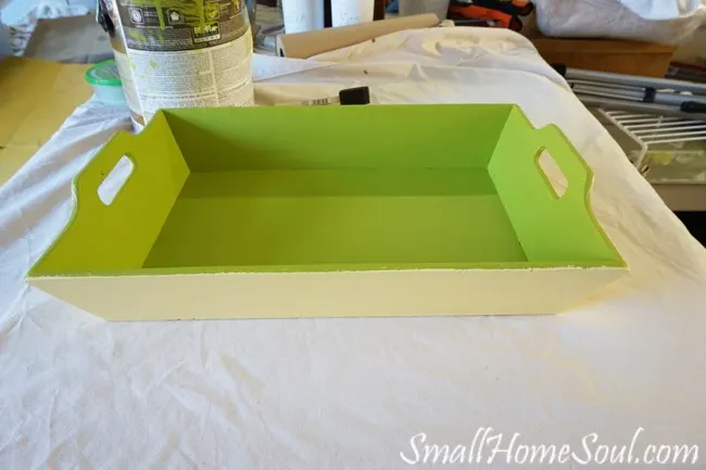 Tray propped on box, outside painted yellow, inside painted green.