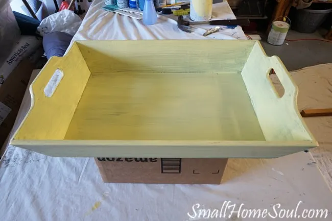 Tray propped on box with first coat of paint.