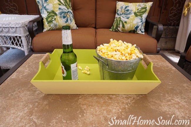 Beachy serving tray with popcorn bucket and bottle of bear.