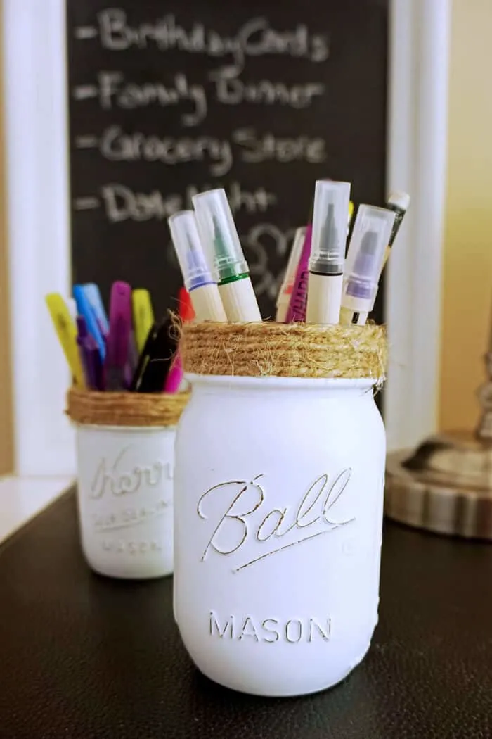 DIY Mason Jar Pencil Holders filled with pencils, pens and markers.