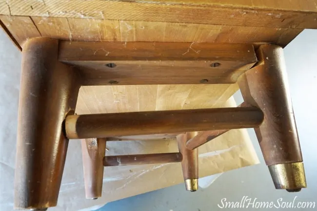 Look from underneath at legs of mid century modern dresser.