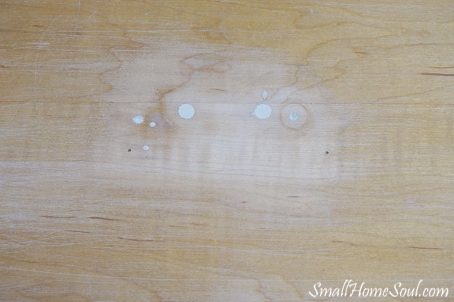 Patched holes in face of dresser looking down.