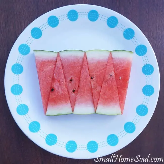 Fresh watermelon in an artsy display  on a blue and white plate.