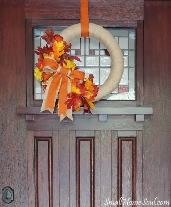 DIY Fall Wreath hanging on brown front door.
