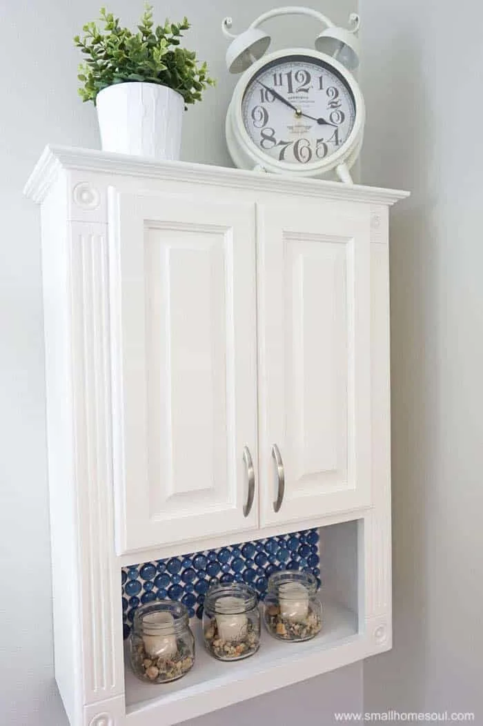 TP cabinet on wall with blue glass backsplash!