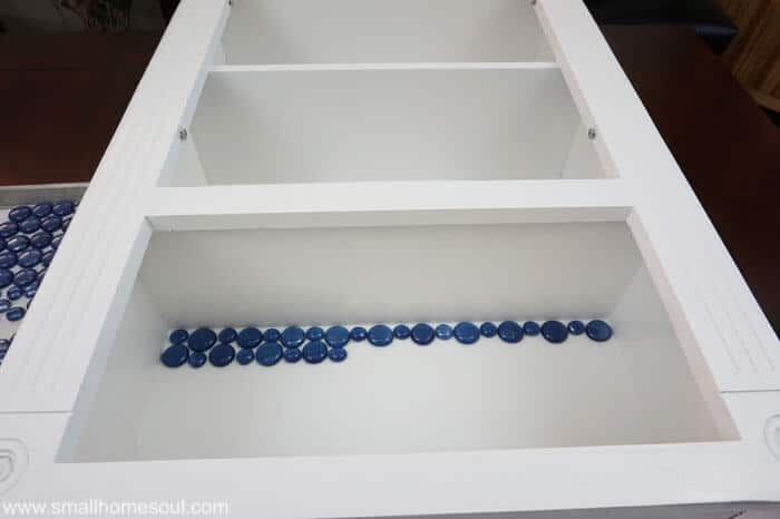Glass beads installed in glass backsplash of TP cabinet