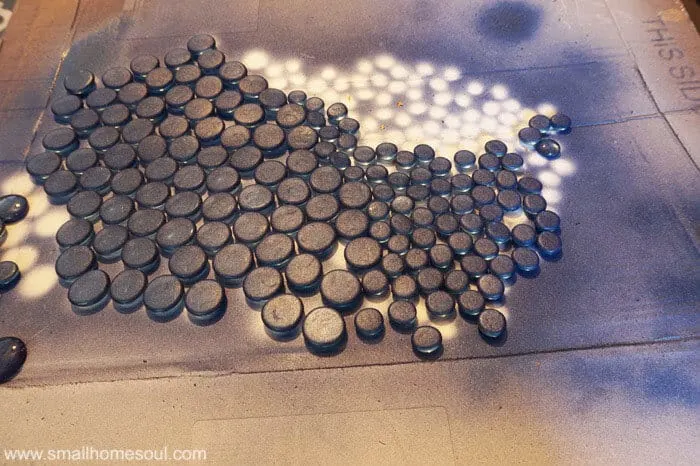 Paint backs of dollar store beads with blue paint for glass backsplash