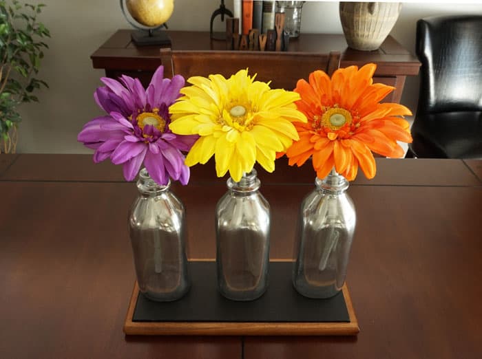 These mirrored milk bottles work beautifully as unique centerpiece! www.smallhomesoul.com