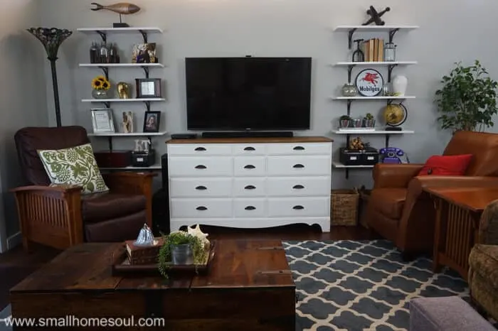 Living room shelves installed and decorated flank the tv and console.