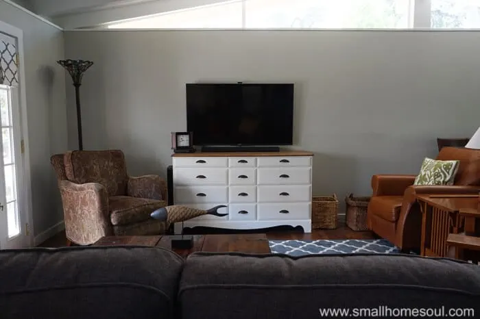 white dresser and tv on wall of living room