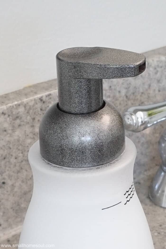 Closeup of foaming soap dispenser updated with spraypaint.