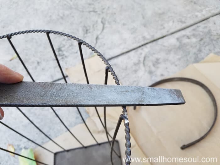 Filing basket of outdoor plant stand using a metal rasp.