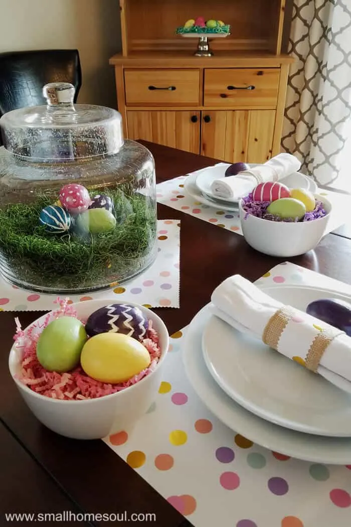 Easter table decorations including painted easter eggs on table set for two.