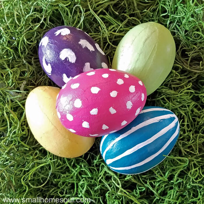 Painted easter eggs piled on green moss.