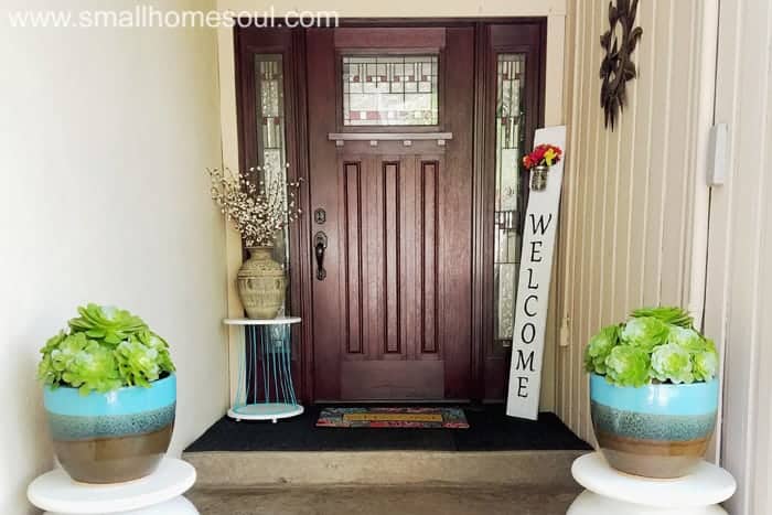 Wide shot of porch with diy welcome sign in corner.