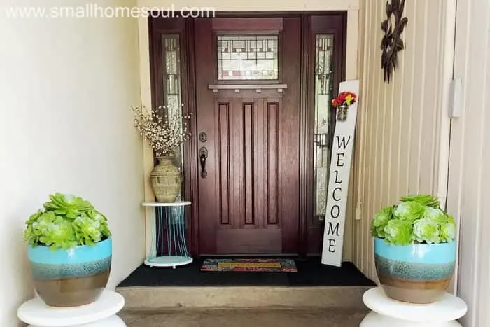 Wide shot of porch with diy welcome sign in corner.