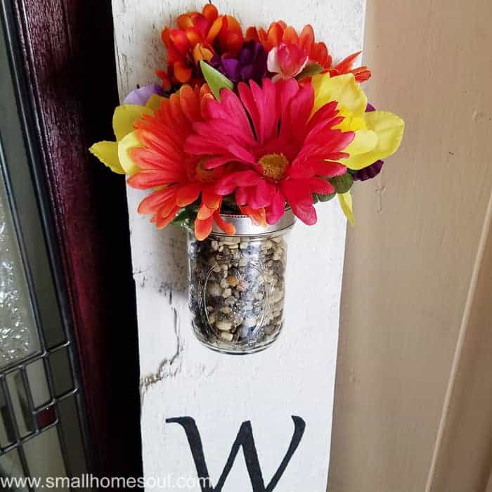 Colorful bouquet at top of diy welcome sign.
