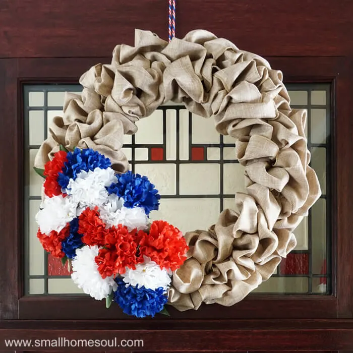 Closeup of July 4th Wreath hung on front door.