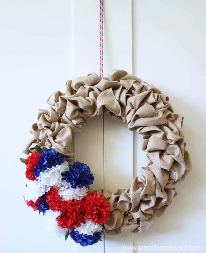A shoestring hangs the July 4th Wreath from the door.
