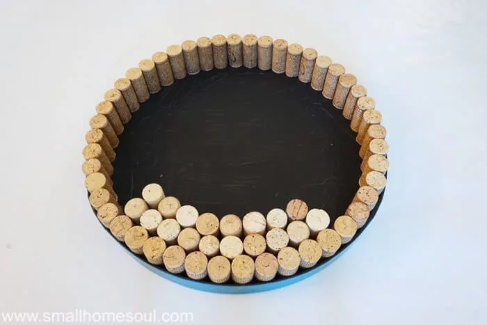 Gluing corks in circle for of lid wine cork board.
