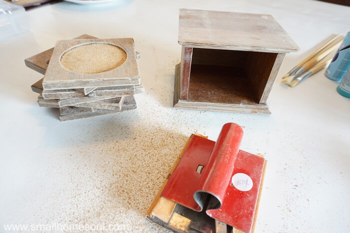 Drink coaster makeover started with lightly sanding all surfaces.