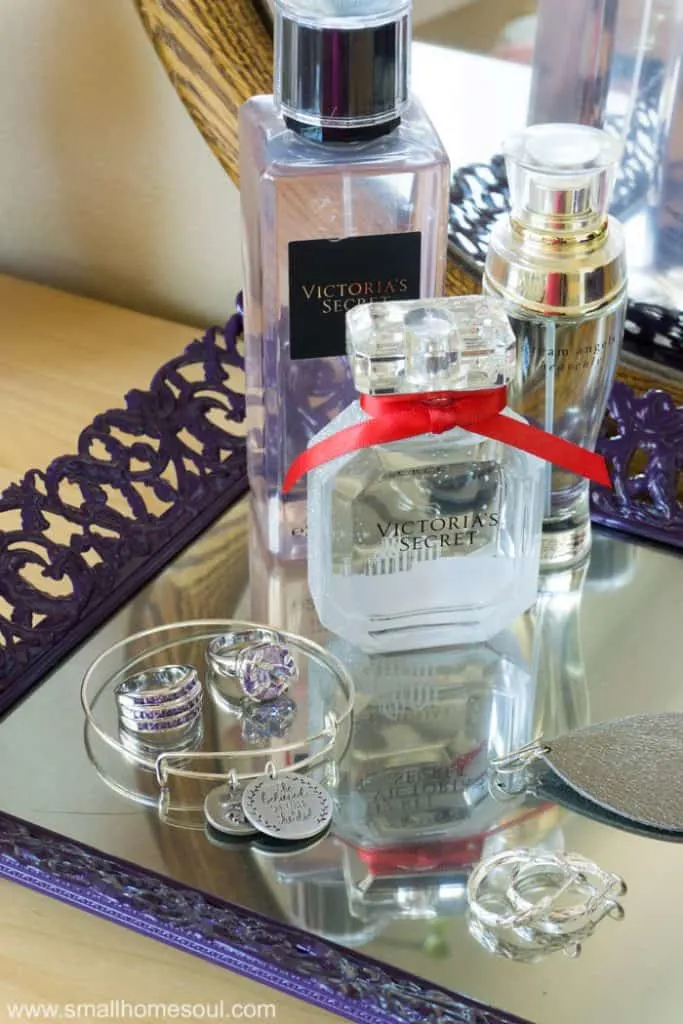 Perfume bottles and jewelry on the jewelry tray.