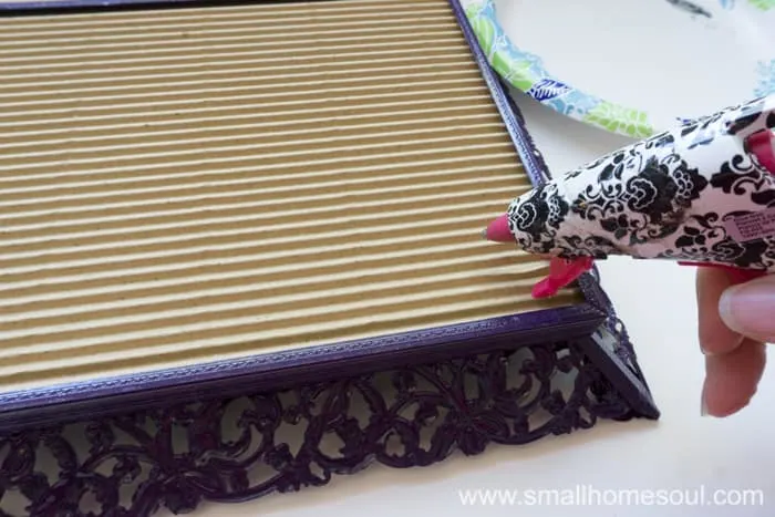 Gluing the cardboard on to the back of the jewelry tray.