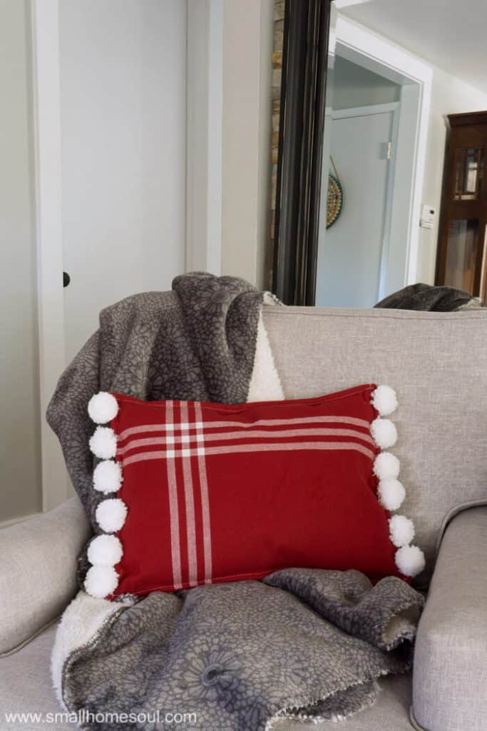 Christmas Pom Pom Pillow with a comfy throw.